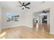 Bright living room featuring sleek hardwood floors and a connecting view to another living space at 4908 Stolls Ave, Tampa, FL 33615