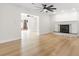 Bright living room featuring sleek hardwood floors and a fireplace at 4908 Stolls Ave, Tampa, FL 33615