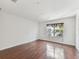 Bedroom with hardwood floors, large window, and ample space for relaxation at 4927 Elizabeth Anne Cir, Tampa, FL 33616