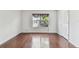 Empty room featuring hardwood flooring, natural light and neutral walls at 4927 Elizabeth Anne Cir, Tampa, FL 33616