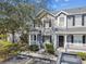 Exterior view of a gray two-story townhome featuring a landscaped yard at 4927 Elizabeth Anne Cir, Tampa, FL 33616