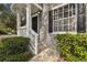 Close up of the entrance with white trim and a view of the window with shutters at 4927 Elizabeth Anne Cir, Tampa, FL 33616