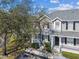 Charming two-story townhome with gray siding, black shutters, and a welcoming front porch at 4927 Elizabeth Anne Cir, Tampa, FL 33616