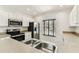 Kitchen featuring stainless steel appliances, ample cabinet space, and a double sink beneath a bright window at 4927 Elizabeth Anne Cir, Tampa, FL 33616