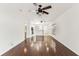 Open living room features hardwood floors, a ceiling fan, and seamless access to the kitchen at 4927 Elizabeth Anne Cir, Tampa, FL 33616