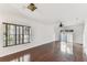 Spacious living room featuring hardwood floors, bright walls, and natural light from the windows at 4927 Elizabeth Anne Cir, Tampa, FL 33616