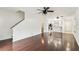 Open floorplan with hardwood floors, with a staircase in the background at 4927 Elizabeth Anne Cir, Tampa, FL 33616