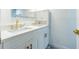 Bathroom with double sink vanity, quartz countertop, and modern gold fixtures at 4965 Puritan Cir # 401, Tampa, FL 33617