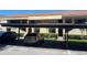 Exterior of building featuring covered parking and manicured landscaping at 4965 Puritan Cir # 401, Tampa, FL 33617