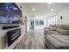 Cozy living room featuring an electric fireplace and an open view into the kitchen at 4965 Puritan Cir # 401, Tampa, FL 33617