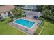 Aerial view of community pool, with lounging area and chairs at 4965 Puritan Cir # 401, Tampa, FL 33617