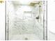 Shower featuring elegant marble-style tiling and modern fixtures at 4965 Puritan Cir # 401, Tampa, FL 33617