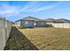 Sprawling backyard featuring new construction gray siding, a patio and privacy fence at 5446 Blue Azure Dr, Wimauma, FL 33598