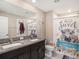 Bathroom featuring a double vanity with granite counters, a toilet, and a shower with a decorative curtain at 5446 Blue Azure Dr, Wimauma, FL 33598