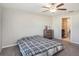 Bedroom featuring neutral walls, carpet flooring, a ceiling fan, and an ensuite bathroom at 5446 Blue Azure Dr, Wimauma, FL 33598