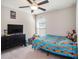 Bedroom featuring neutral walls, carpet flooring, a ceiling fan, and a window with blinds at 5446 Blue Azure Dr, Wimauma, FL 33598