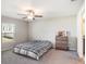 Bright bedroom featuring neutral walls, carpet flooring, a ceiling fan, and a window at 5446 Blue Azure Dr, Wimauma, FL 33598