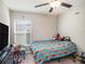 Bedroom featuring neutral walls, carpet flooring, a ceiling fan, and a window with blinds at 5446 Blue Azure Dr, Wimauma, FL 33598