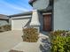 View of home's front door and garage at 5446 Blue Azure Dr, Wimauma, FL 33598