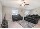 Living room featuring tile flooring, a ceiling fan, and a sliding glass door at 5446 Blue Azure Dr, Wimauma, FL 33598