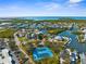 Aerial view of waterfront homes and blue tennis courts at 6029 Bayway Ct, New Port Richey, FL 34652