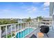 Balcony view with a waterfront and pool with chair seating for relaxing at 6029 Bayway Ct, New Port Richey, FL 34652