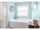 Bright bathroom with a shower, a soaking tub, and beach-themed decorations at 6029 Bayway Ct, New Port Richey, FL 34652