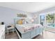 Bedroom with light blue walls, a king bed, and sliding glass doors to a balcony at 6029 Bayway Ct, New Port Richey, FL 34652