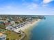 Coastal community with beach access, waterfront homes, and palm-lined streets, captured from an aerial perspective at 6029 Bayway Ct, New Port Richey, FL 34652