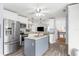 Bright kitchen with stainless steel appliances, white cabinets, and an island with seating at 6029 Bayway Ct, New Port Richey, FL 34652