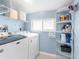 Bright laundry room with shelving and appliances at 6029 Bayway Ct, New Port Richey, FL 34652