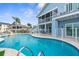 Inviting blue backyard pool, blue house, screened-in porch and backyard at 6029 Bayway Ct, New Port Richey, FL 34652