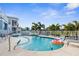 Inviting blue backyard pool, blue house, and landscaped backyard at 6029 Bayway Ct, New Port Richey, FL 34652