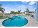 Inviting blue backyard pool with lounge chairs and fenced perimeter at 6029 Bayway Ct, New Port Richey, FL 34652