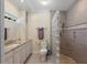 Beautiful bathroom features granite countertops, a toilet, and a shower stall with glass block at 635 13Th Ne Ave, St Petersburg, FL 33701