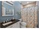 Bathroom with granite sink, tiled shower, and colorful shower curtain at 635 13Th Ne Ave, St Petersburg, FL 33701