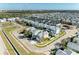 Stunning aerial view of a colorful two-story home on a corner lot in a desirable neighborhood with manicured lawns at 6571 Simone Shores Cir, Apollo Beach, FL 33572