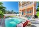 Backyard features a private pool, outdoor kitchen, and covered patio perfect for entertaining at 6571 Simone Shores Cir, Apollo Beach, FL 33572