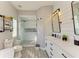 Bathroom featuring a glass shower with detailed tiles and a double vanity at 6571 Simone Shores Cir, Apollo Beach, FL 33572