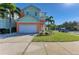 Beautiful two-story home features lush landscaping, a spacious driveway, and a welcoming front porch, perfect for families at 6571 Simone Shores Cir, Apollo Beach, FL 33572