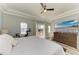 Main bedroom showcasing modern decor, a ceiling fan, and a balcony at 6571 Simone Shores Cir, Apollo Beach, FL 33572