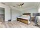 Main bedroom showcasing modern decor, a ceiling fan, and hardwood floors at 6571 Simone Shores Cir, Apollo Beach, FL 33572