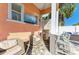 Outdoor kitchen and bar area featuring stainless steel grill, stone backsplash, and outdoor television at 6571 Simone Shores Cir, Apollo Beach, FL 33572