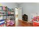 Playroom with hardwood floors features a large storage shelf, toys, and open doorway at 6571 Simone Shores Cir, Apollo Beach, FL 33572