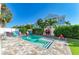 Beautiful backyard pool with colorful Adirondack chairs and lush landscaping creates a private outdoor oasis at 6571 Simone Shores Cir, Apollo Beach, FL 33572