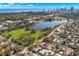 Aerial view of a home near a lake and city with lush trees in a neighborhood at 719 21St N Ave, St Petersburg, FL 33704