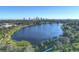 Expansive aerial view of a serene lake framed by lush greenery and a distant cityscape at 719 21St N Ave, St Petersburg, FL 33704