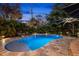 Backyard oasis featuring a luxurious pool, surrounded by lush landscaping and a brick-paved patio perfect for relaxing at 719 21St N Ave, St Petersburg, FL 33704