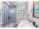 Bathroom featuring a shower with blue star tiles, stylish fixtures, and a stained glass window at 719 21St N Ave, St Petersburg, FL 33704