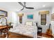 Bedroom features wood floors, vintage furniture, and natural light from the multiple windows at 719 21St N Ave, St Petersburg, FL 33704